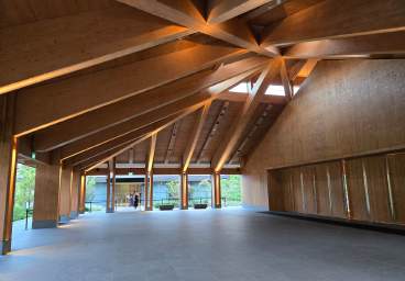 Zero-energy timber event hall in water gardens featuring an authentic Japanese tea house